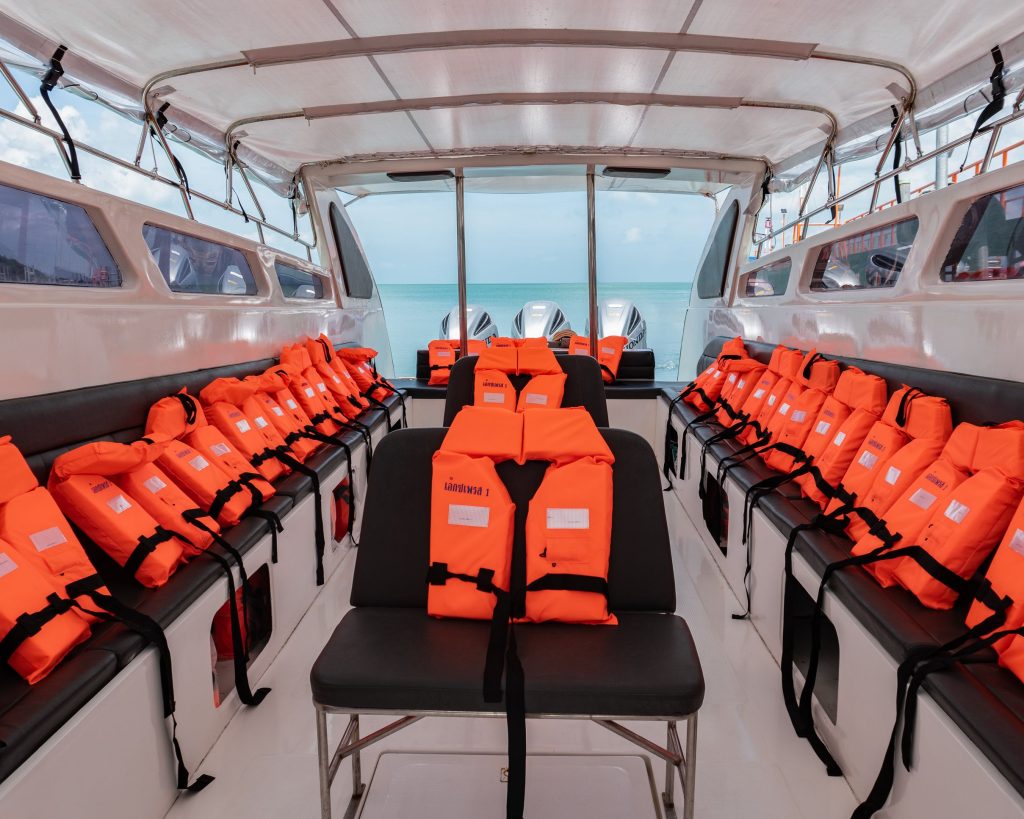 Interior seating of a Songserm Express speedboat, featuring compact rows of cushioned seats designed for quick and comfortable island travel.